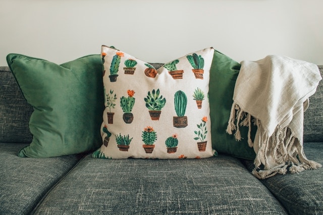 Decorative Pillows with cactus print on a grey couch